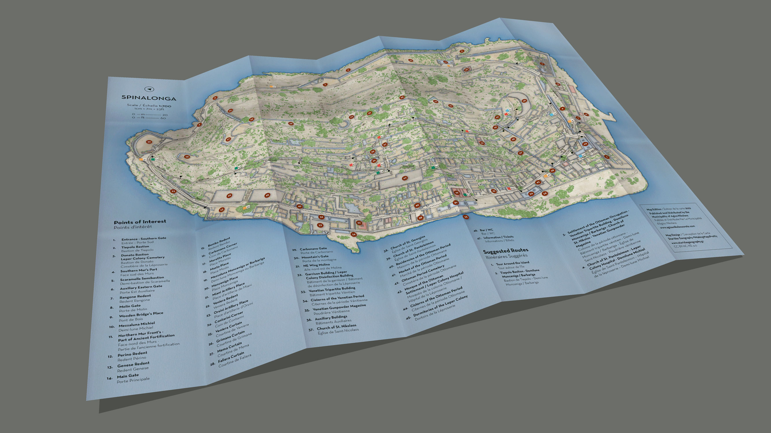 Folded paper mockup of the Spinalonga Islet map showing how the printed map is designed to be handled and used in the field.